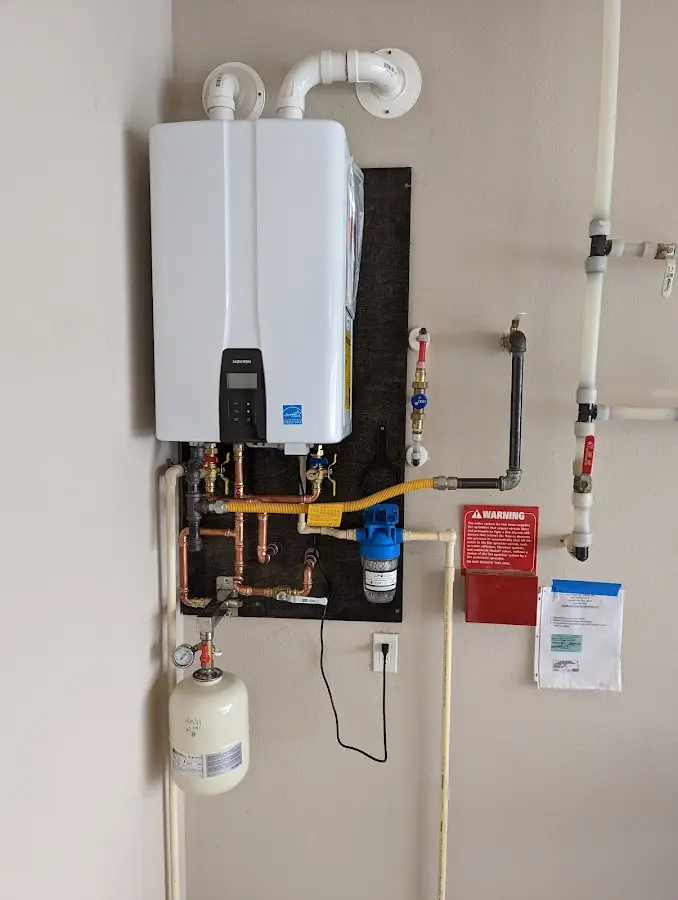 Professional plumber installing copper piping in a Brighton home
